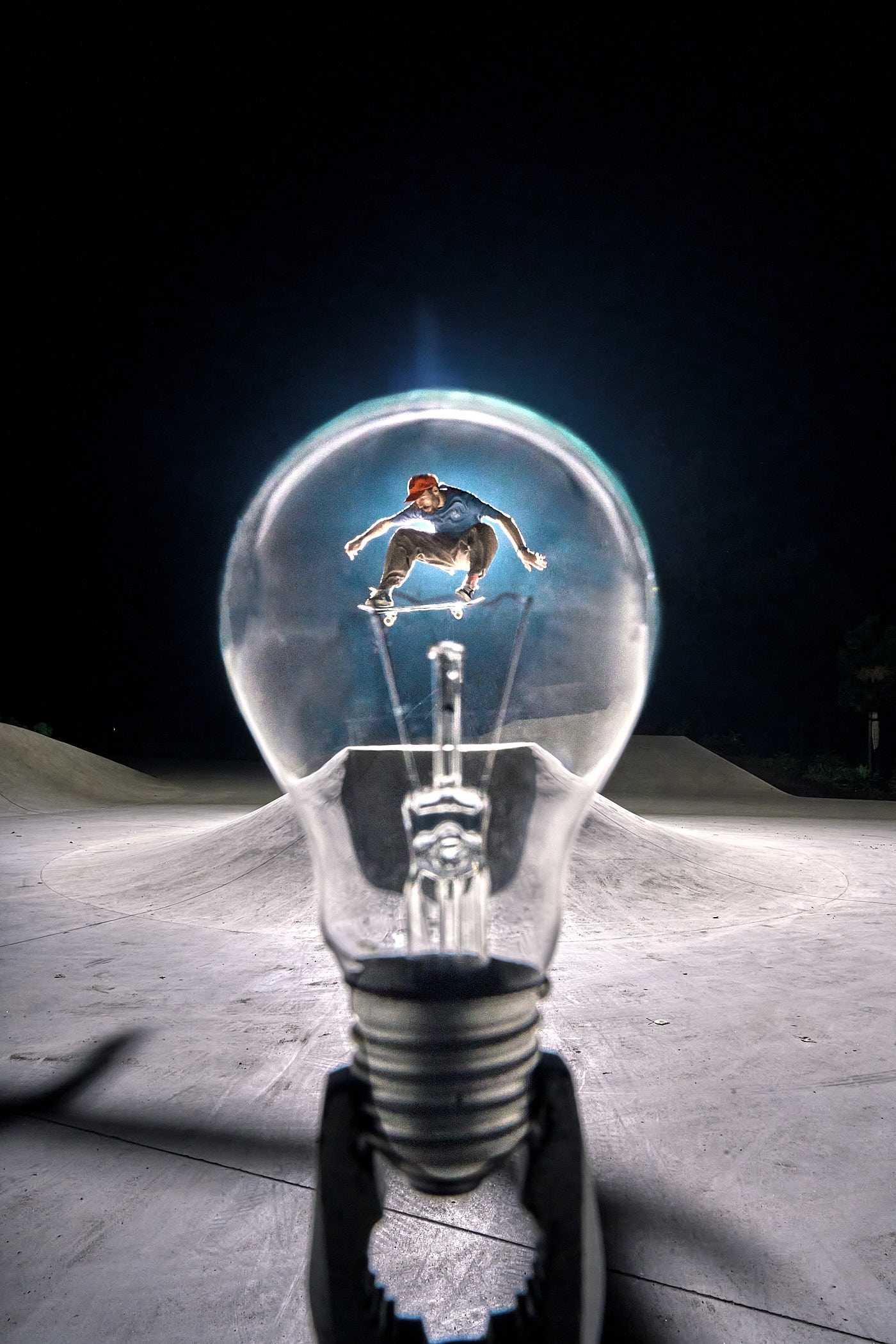 A photograph by Volodya Voronin of a skateboarder framed in a lightbulb