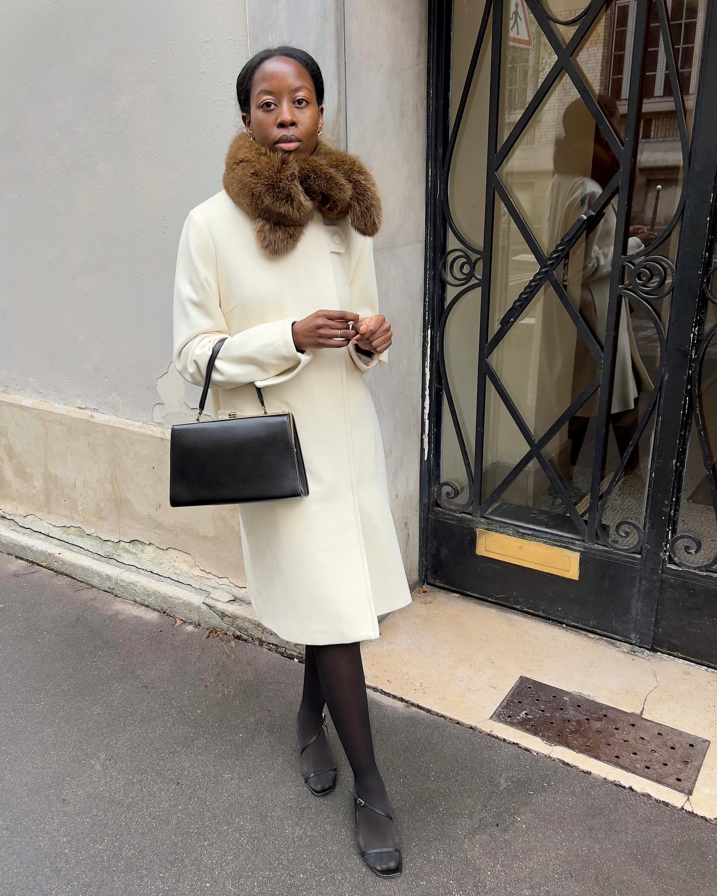 An image of @sylviemus_ wearing an opera coat.