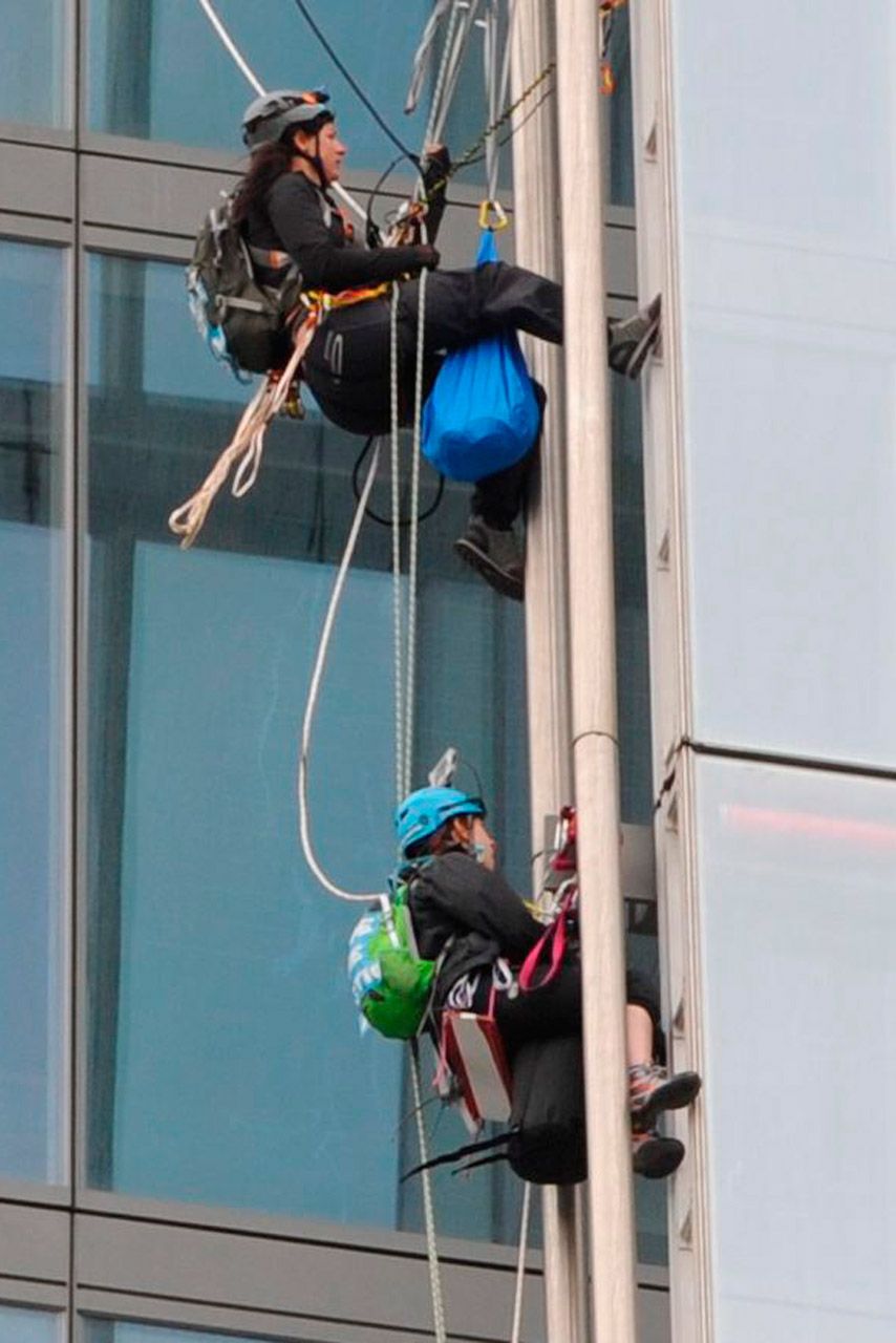 Female Greenpeace protestors climb the shard