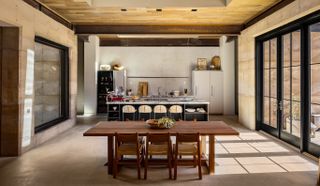 morning dove, a new house at twentynine palms by homestead modern, showing rammed earth walls, rough and contemporary volumes and windows out to desert landscape views