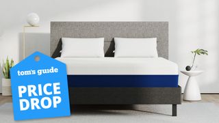 Amerisleep AS2 mattress on a gray bed in a minimalist white room