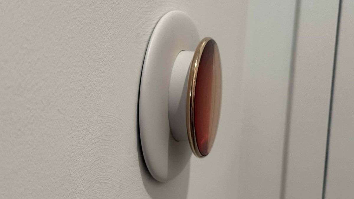 Side view of Google Nest Learning Thermostat (4th Gen) showing the thickness of the thermostat dial and its mounting plate, and how far they protrude from the wall