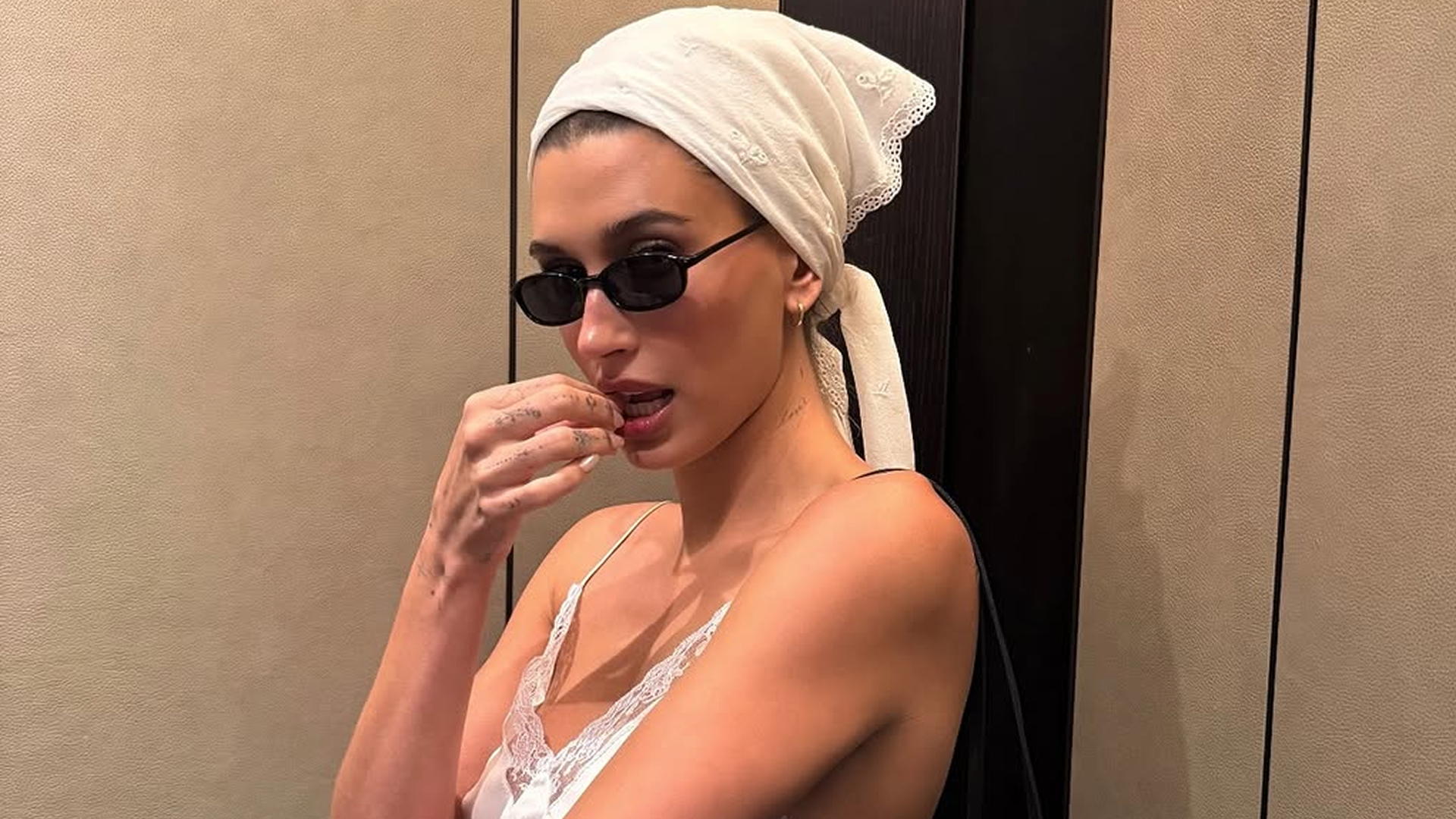 Hailey Bieber styled a lace lingerie-inspired skirt set from Magda Butrym with the triangle hair scarf trend and a new Chanel bag