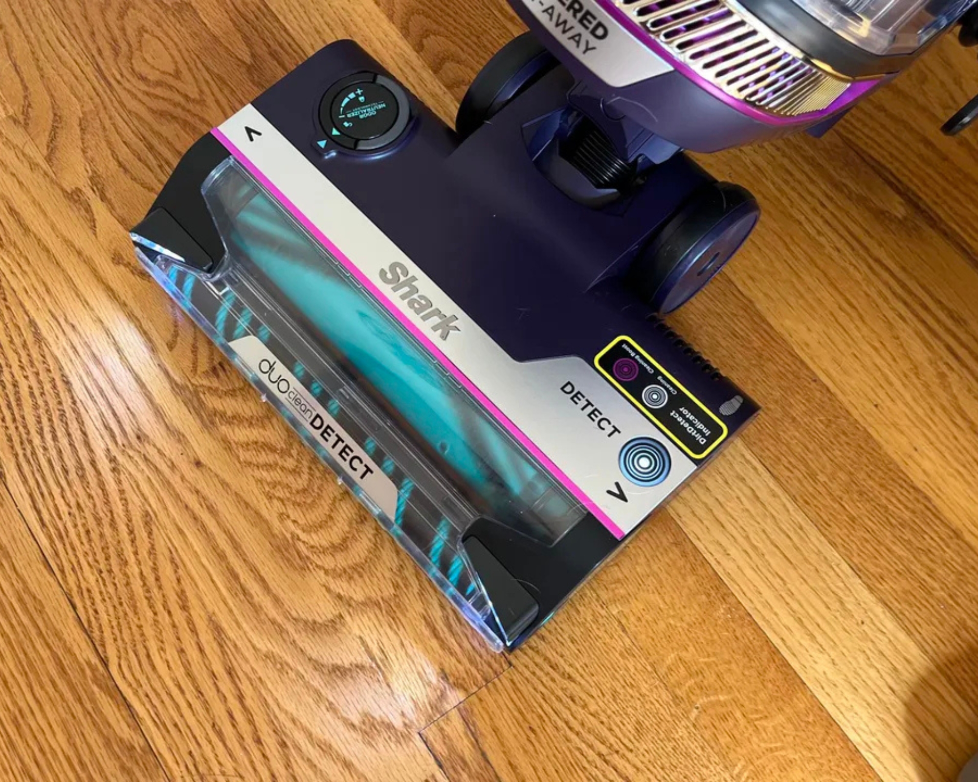 Shark POWERDETECT Upright Vacuum main floorhead on wooden floor, with lights