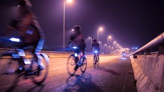 a photo of someone cycling at night 