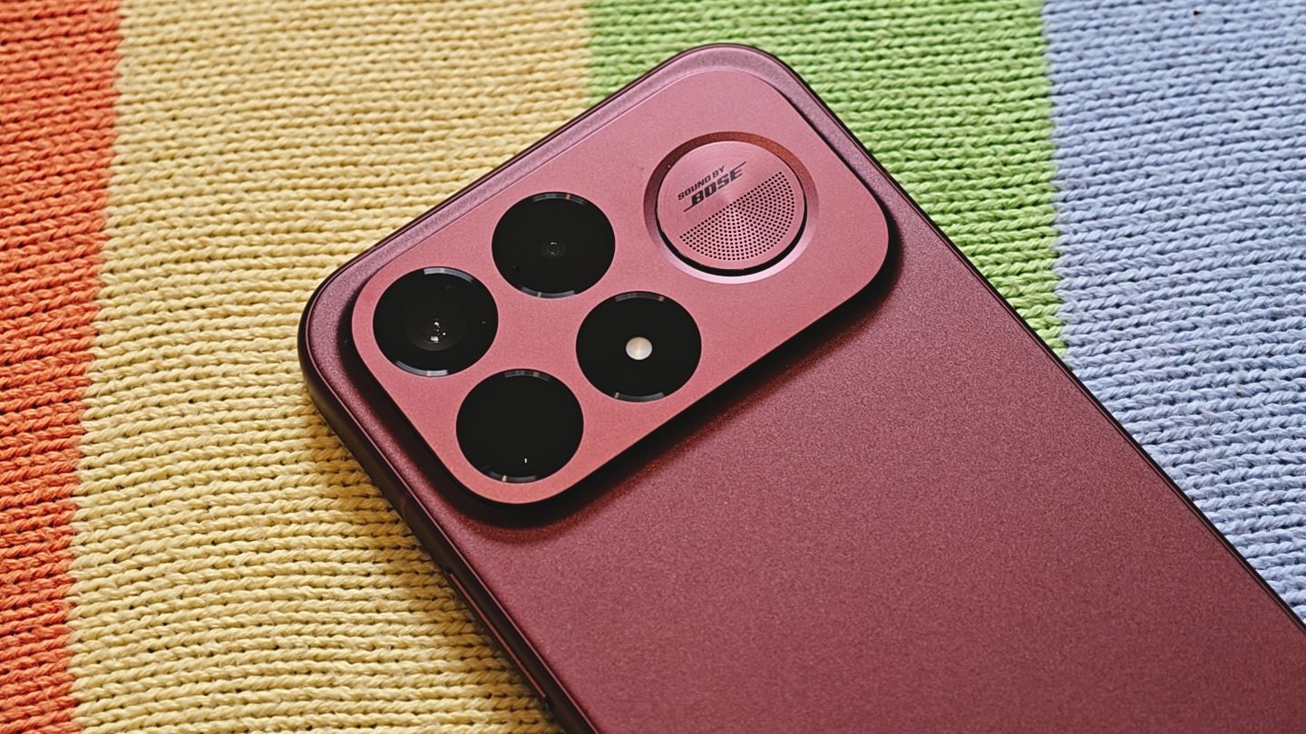 The Poco F9 Ultra being held in the hand and resting on a table
