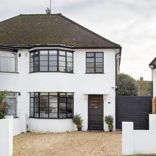 exterior of house with white walls and black window frames