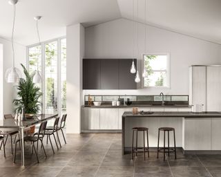 A large white kitchen with gray stone flooring and gloss dining table illustrating how to design a modern kitchen.