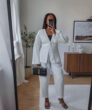 @femmeblk wearing a white suit