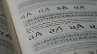 Photograph of a printed book of fonts showing different styles and weights.