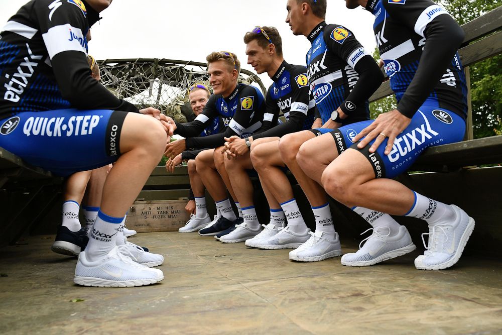 Riders of the France's Cofidis cycling team take part in a parade aboard an World War II US army vehicle during the team presentation