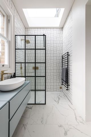a small wet room with a crittall style screen