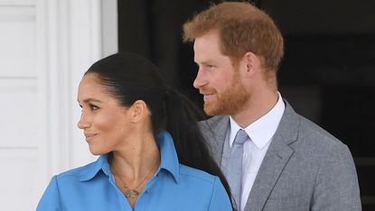 Prince Harry and Meghan Markle gaze away from the camera while in Australia