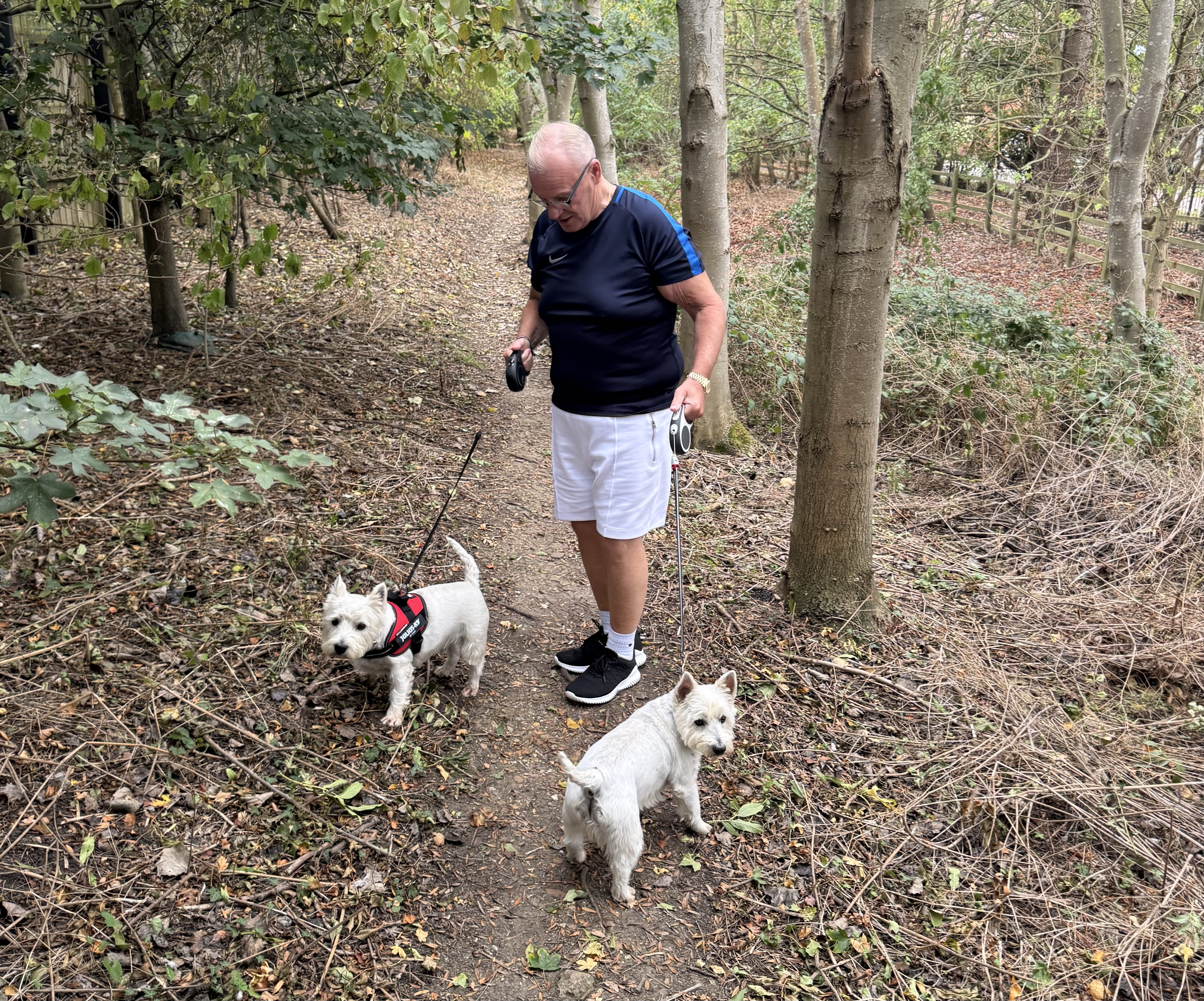Steve Evans walking his dogs in woods near his home in Peterborough