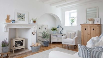 white painted sitting room of an old stone cottage
