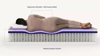 A woman sleeping on her side on the Purple Restore Hybrid mattress