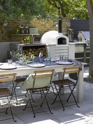 outdoor dining with pizza oven