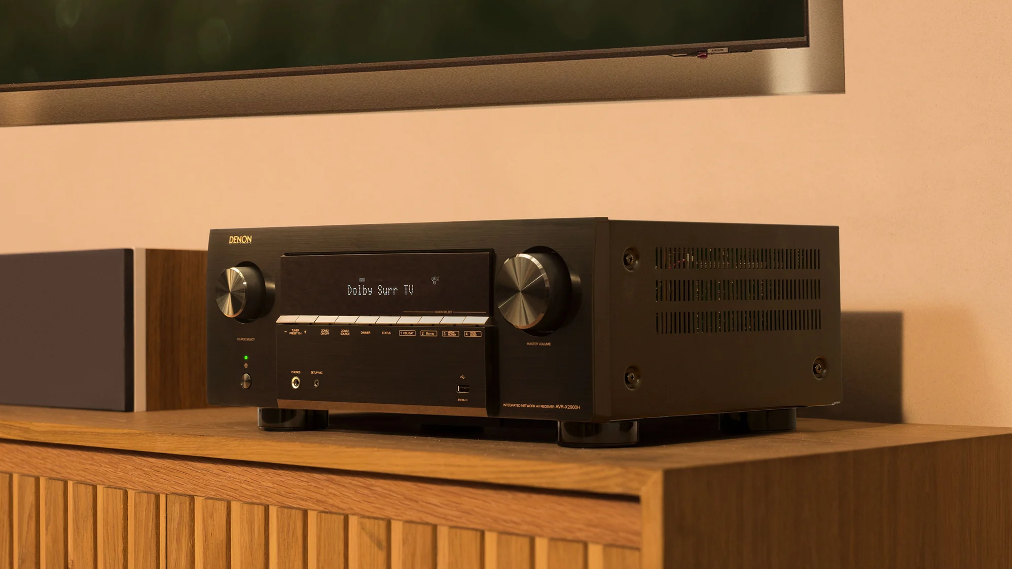 The Denon AVR-X2900H on an entertainment center.