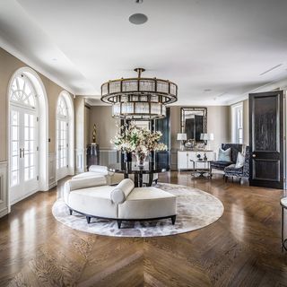 hallway with chandelier and wooden flooring