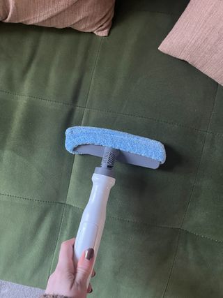 Using the fabric attachment to steam clean a couch