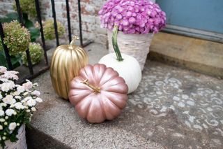 painted pumpkins on a porch