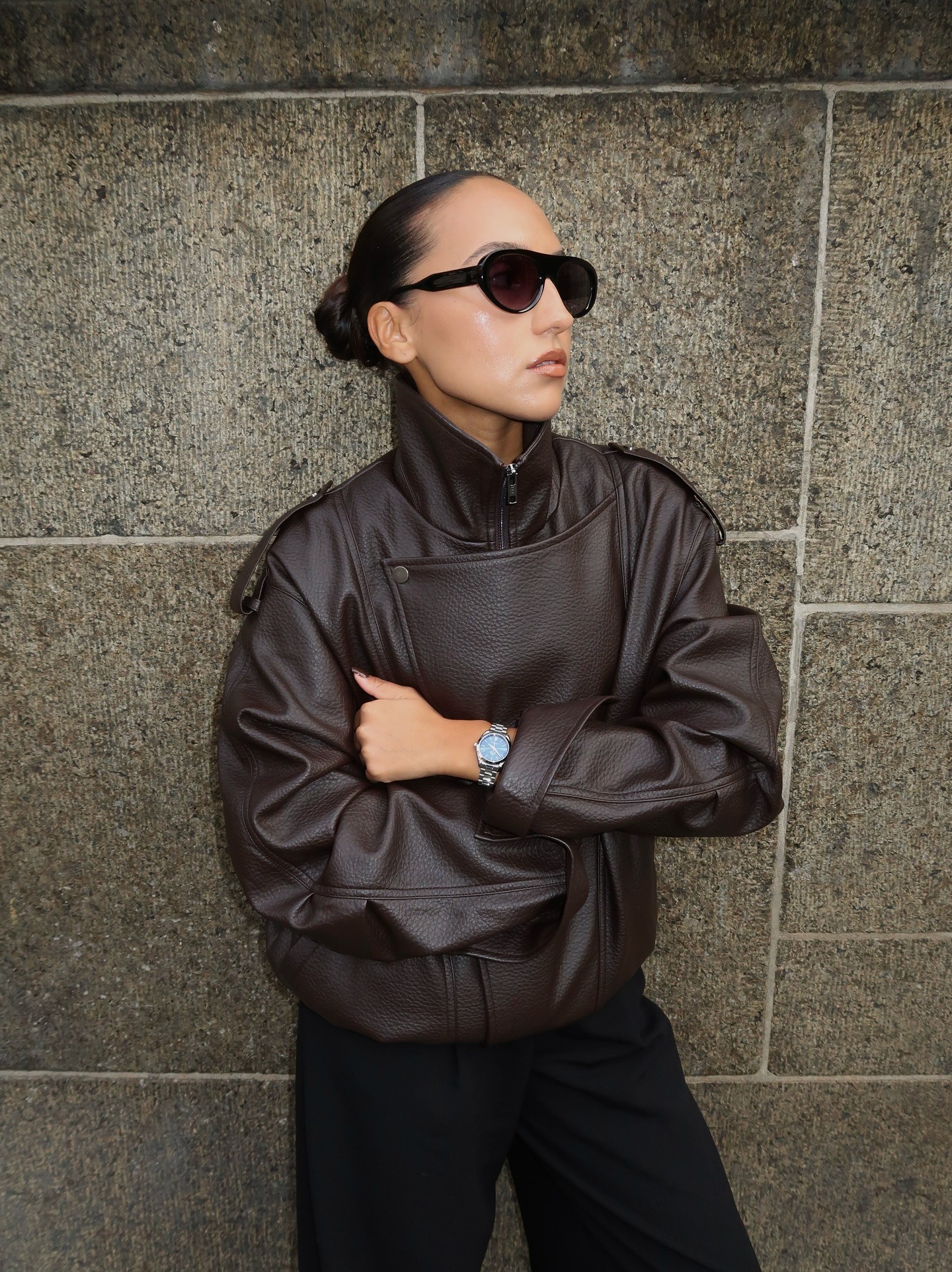 Woman wearing leather funnel neck jacket.