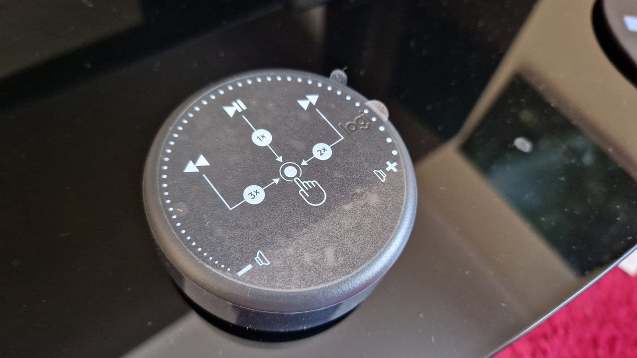 The Logitech Z407 control puck with its label stickers showing its functionality