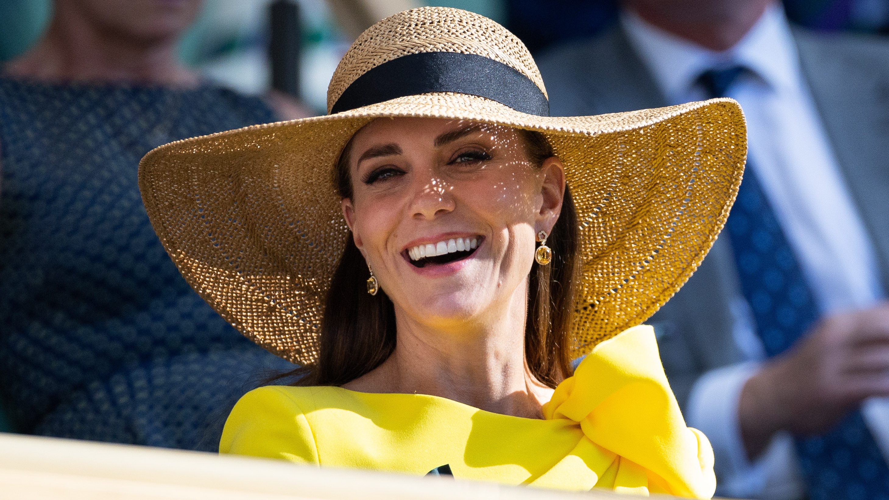 Catherine, Princess of Wales smiles, wearing a sunhat, in the royal box during the Men&#039;s Doubles Final at Wimbledon 2022