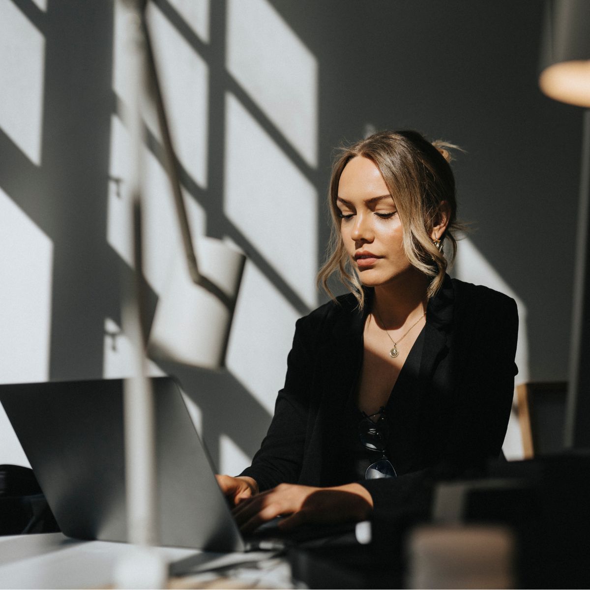 Woman in an office, sat at her desk working