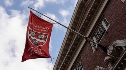 A banner for Harvard University&rsquo;s Graduate School of Arts and Sciences is seen on a building.