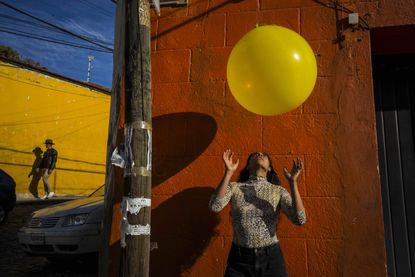 Veuve Clicquot Magnum Photos Emotions of the Sun: woman bounces yellow balloon