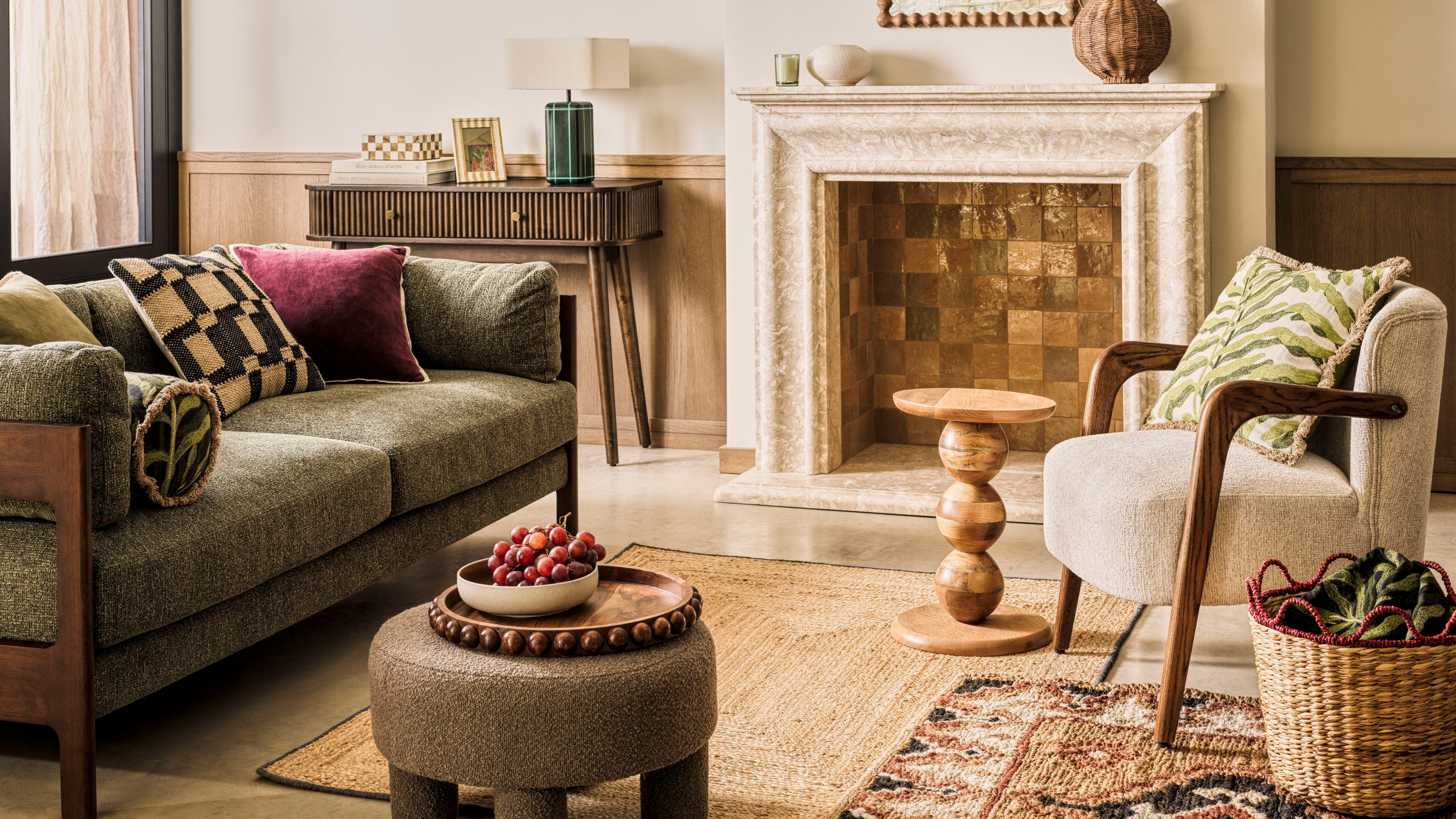 Living room withh green sofa, foot stool and white accent chair.
