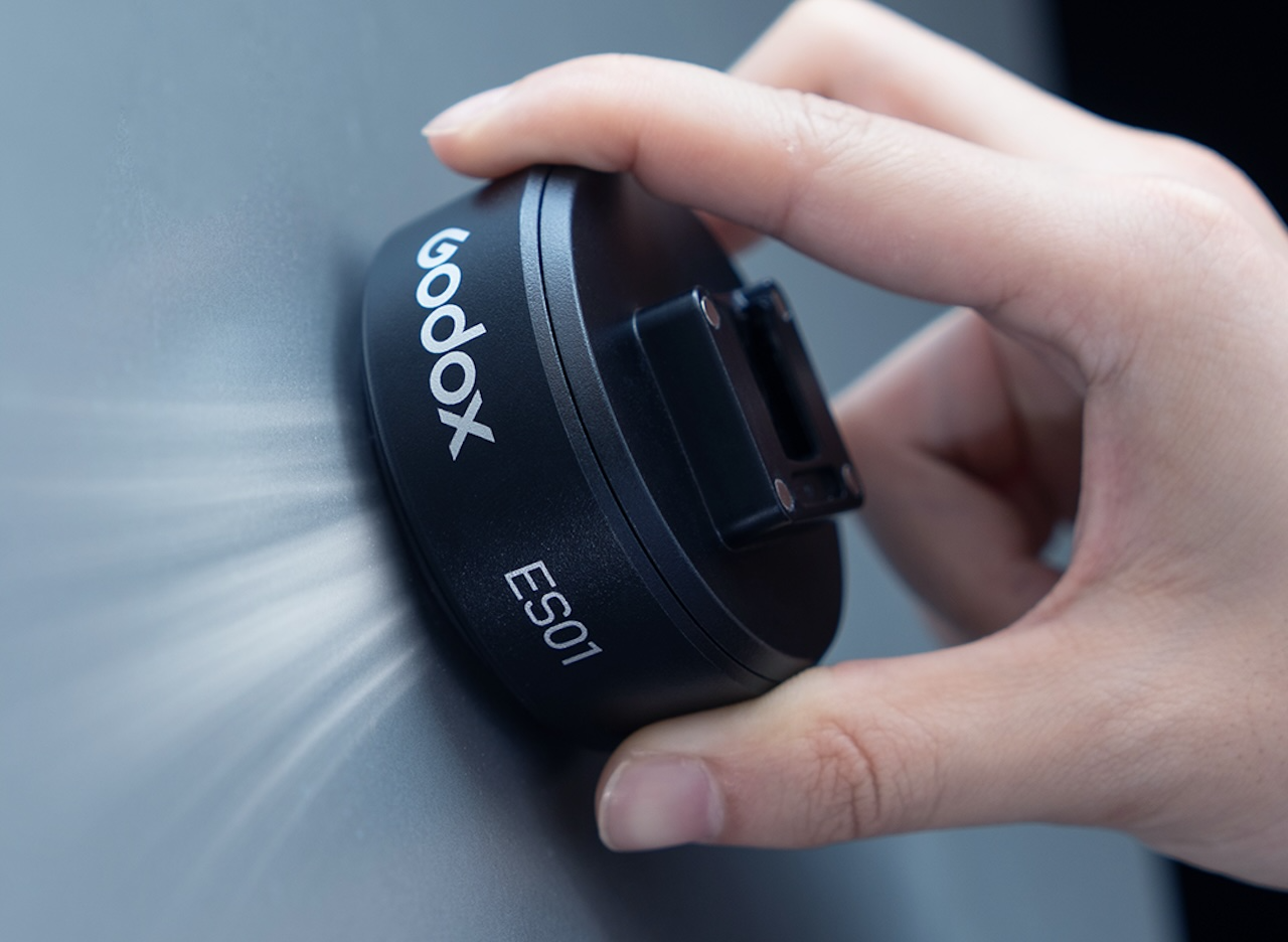 Godox ES-01 suction mount being pressed against a wall