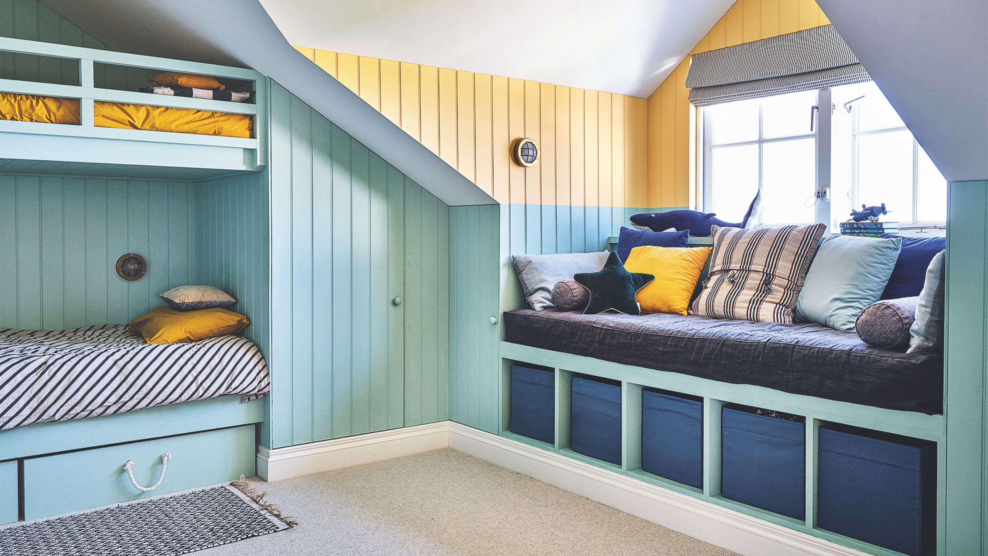 Boy's bedroom with panelled walls, bunkbeds, and a window seat with storage underneath