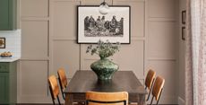 a taupe dining room wall with a modern paneling design