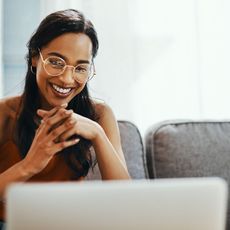 Woman in glasses looking at laptop