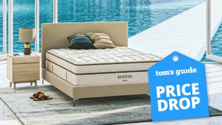The Saatva Classic mattress pictured in a pool house overlooking a bright blue swimming pool on a warm, sunny day