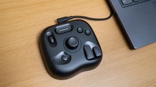 TourBox Lite attached to a computer on a desk