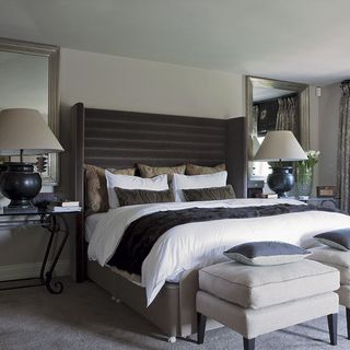 bedroom with grey coloured rug two lamps and