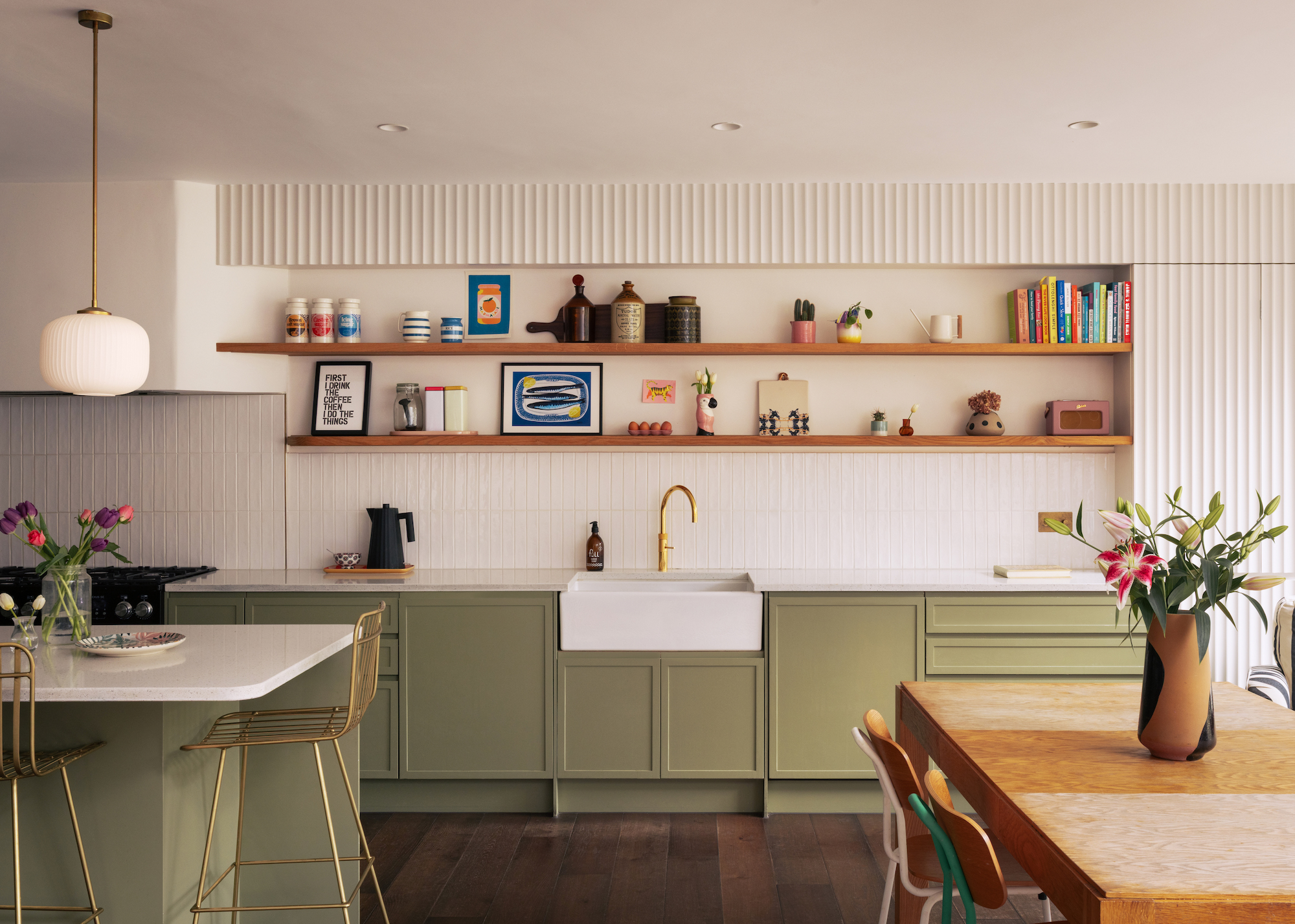 green kitchen with white fluted surfaces