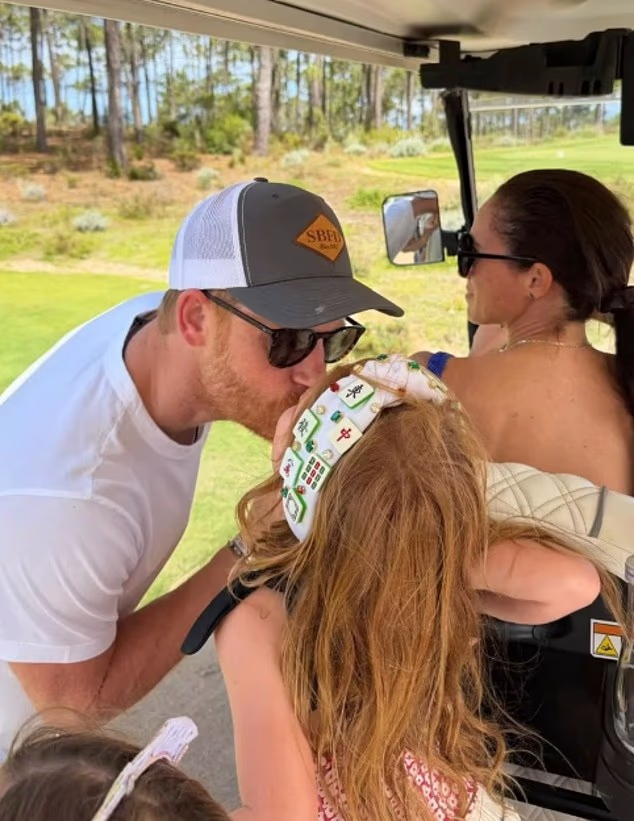 Prince Harry giving Princess Lilibet a kiss in a golf cart