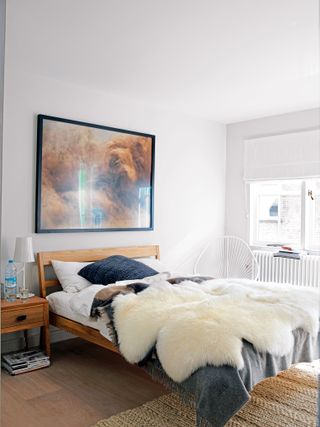 White bedroom with fur throw