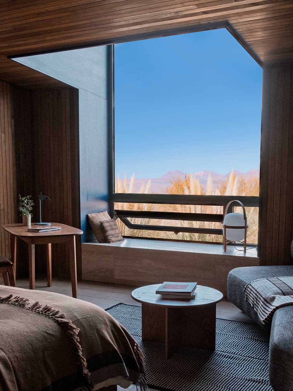 A chilean luxury hotel features Japandi interiors punctuated by wooden surfaces, earthy tones, and plenty of natural light.