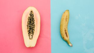 papaya and banana from above on pink and blue background