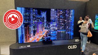 Samsung OLED TV with a city on screen and a tag that reads "Adventures in AV"