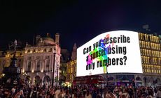 Ai vs AI: piccadilly circus with Ai Weiwei question displayed on building: Can you describe a sunset using only numbers?