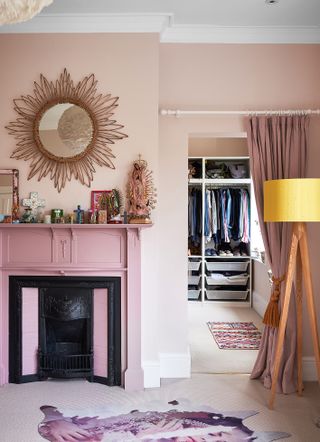 Pink bedroom with fireplace and walk in closet