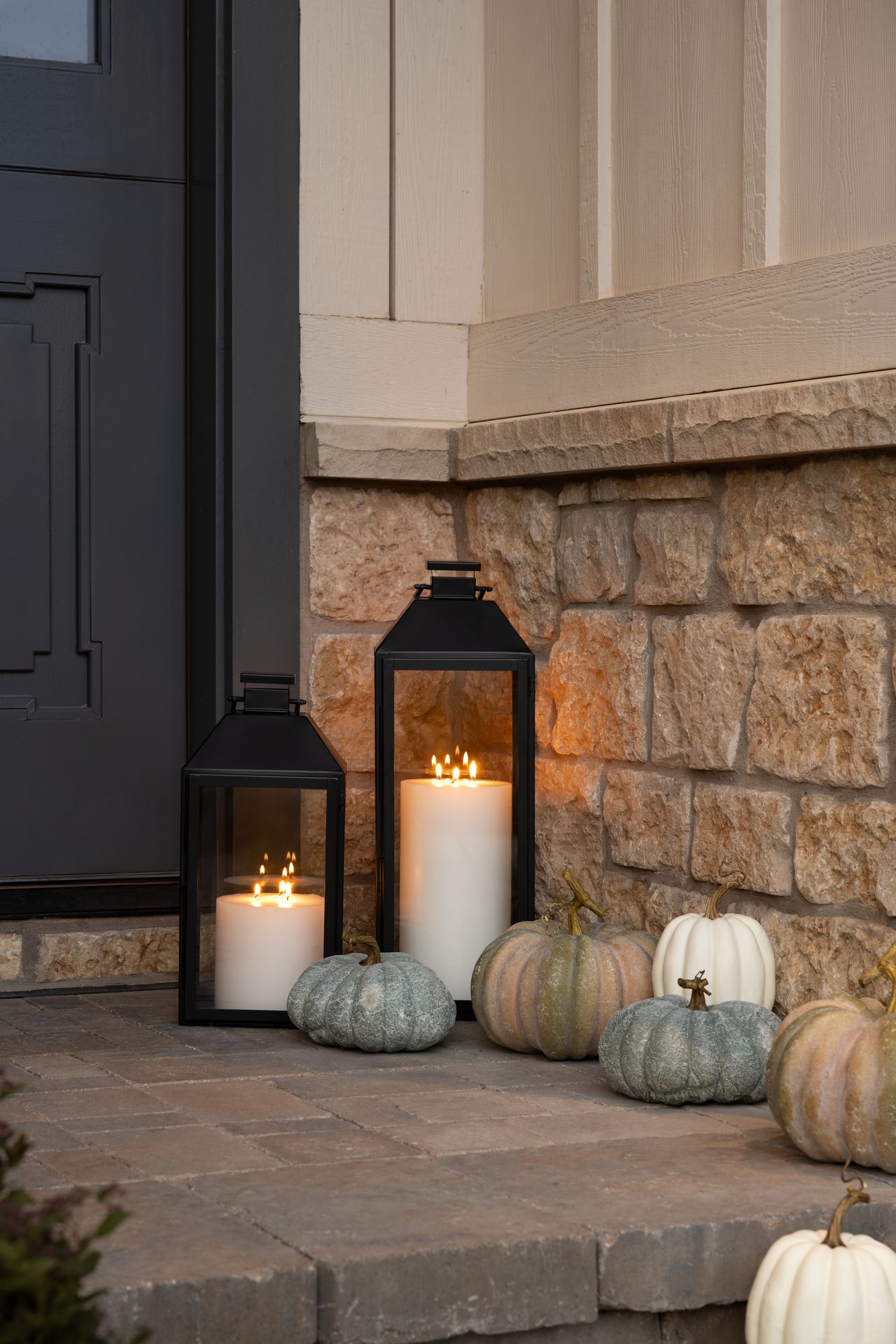 Outdoors with tiny pumpkins and lanterns