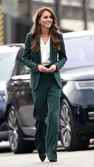 Kate Middleton in a green trouser suit
