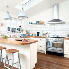 white attic kitchen with worktop and hanging lights